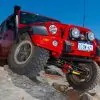 OME 4 inch Lift Kit installed of a red Jeep Wrangler JK 2007-2015