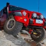 OME 4 inch Lift Kit installed of a red Jeep Wrangler JK 2007-2015